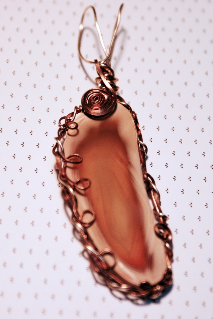 Wire-wrapped agate rock pendant. 